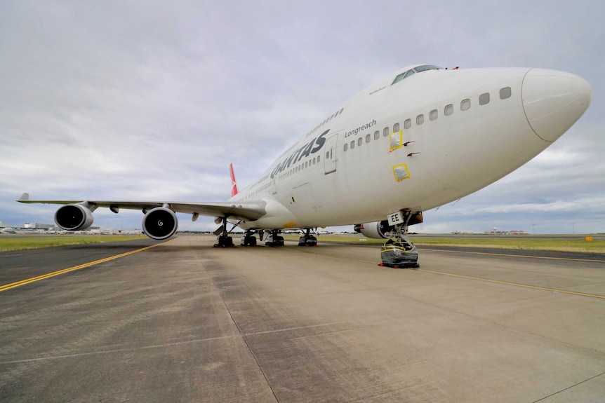 Photo of a Qantus jet sitting on a runway.