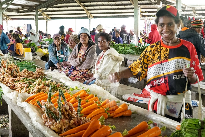 Women working at a stall at a market place in PNG