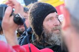 Fedor Konyukhov stands amongst the crowd looking up at the sky