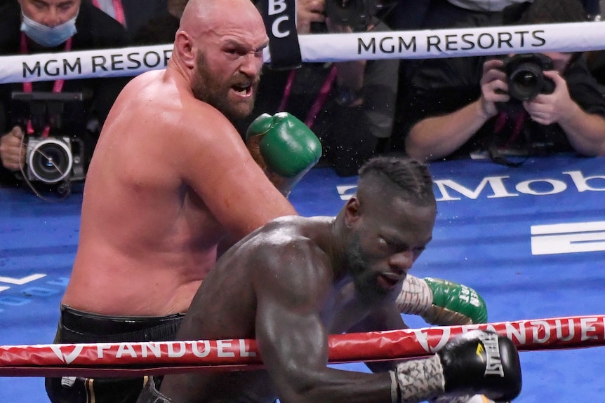 Tyson Fury punches Deyontay Wilder