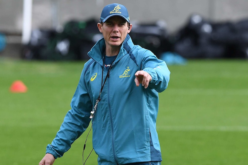 Stephen Larkham points to his left at a Walabies training session.