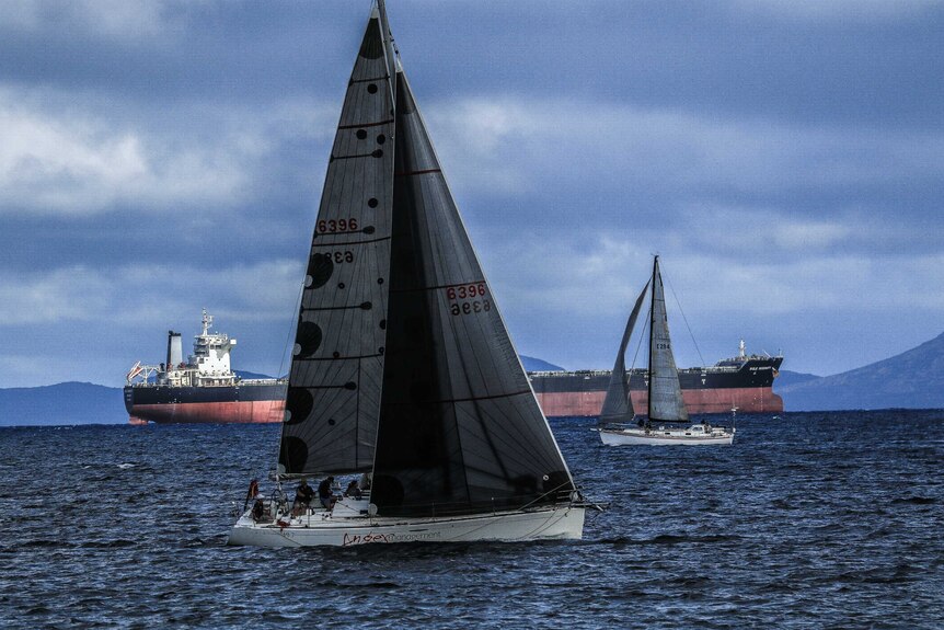 Yacht sailing with crew on board