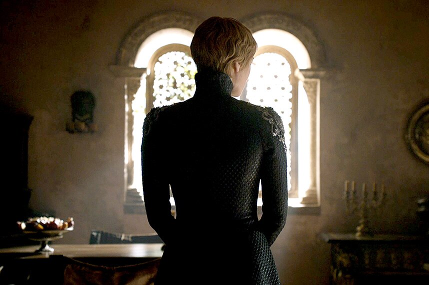 Cersei Lannister is silhouetted by a medieval-style window