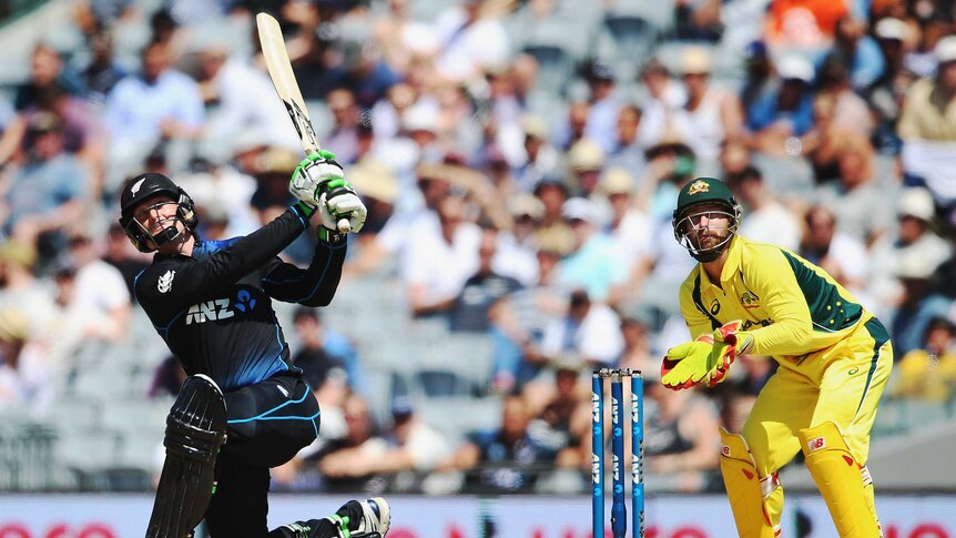 On the attack ... Martin Guptill hits a six en route to posting a half-century against Australia