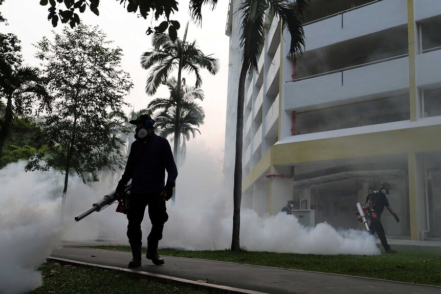 Workers fogging a housing estate at Aljunied Crescent in Singapore.