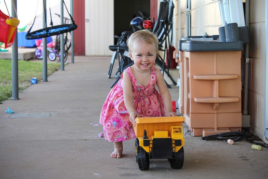 Two-year-old Evieanna Gillic plays with a toy truck.