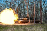 tank among trees with flames coming out of turret