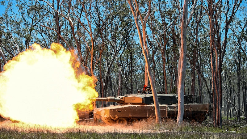 tank among trees with flames coming out of turret