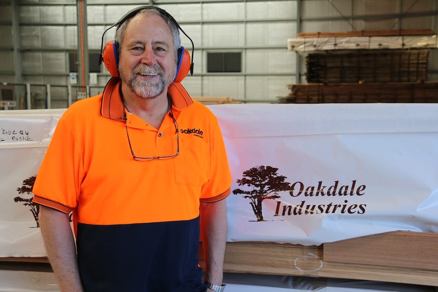 John Hollis from Oakdale Industries wears earmuffs in a workshop.