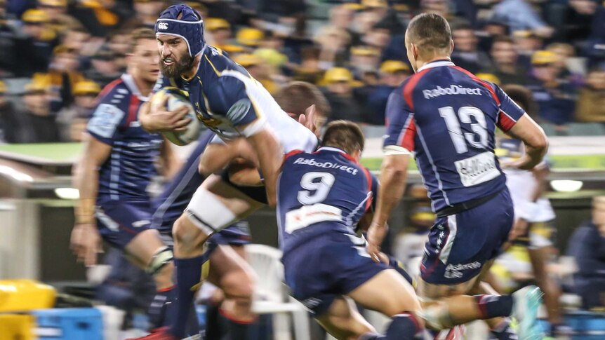 Brumbies player Scott Fardy breaks through the Rebels defence during the Brumbies win over the Rebels.