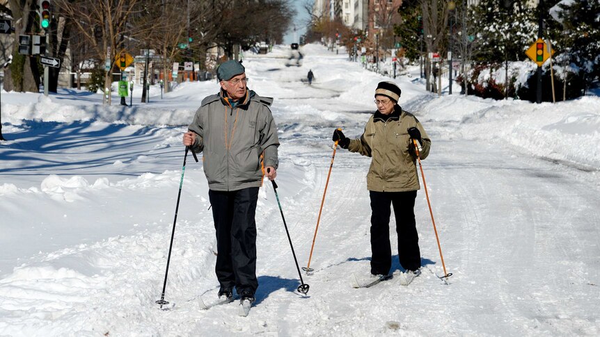 People use cross-country skis on the street in Washington.
