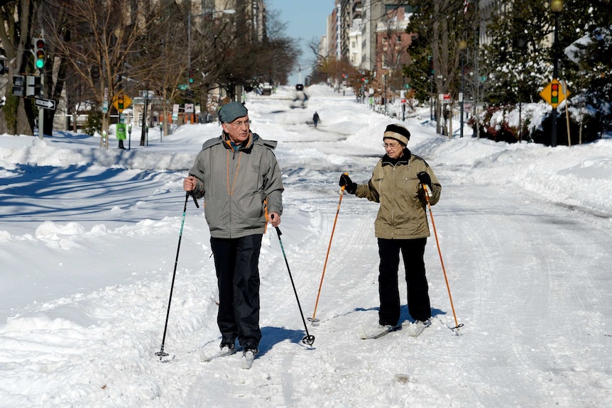 People use cross-country skis on the street in Washington.
