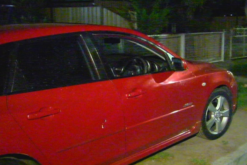 Gunshot holes in the side of a car