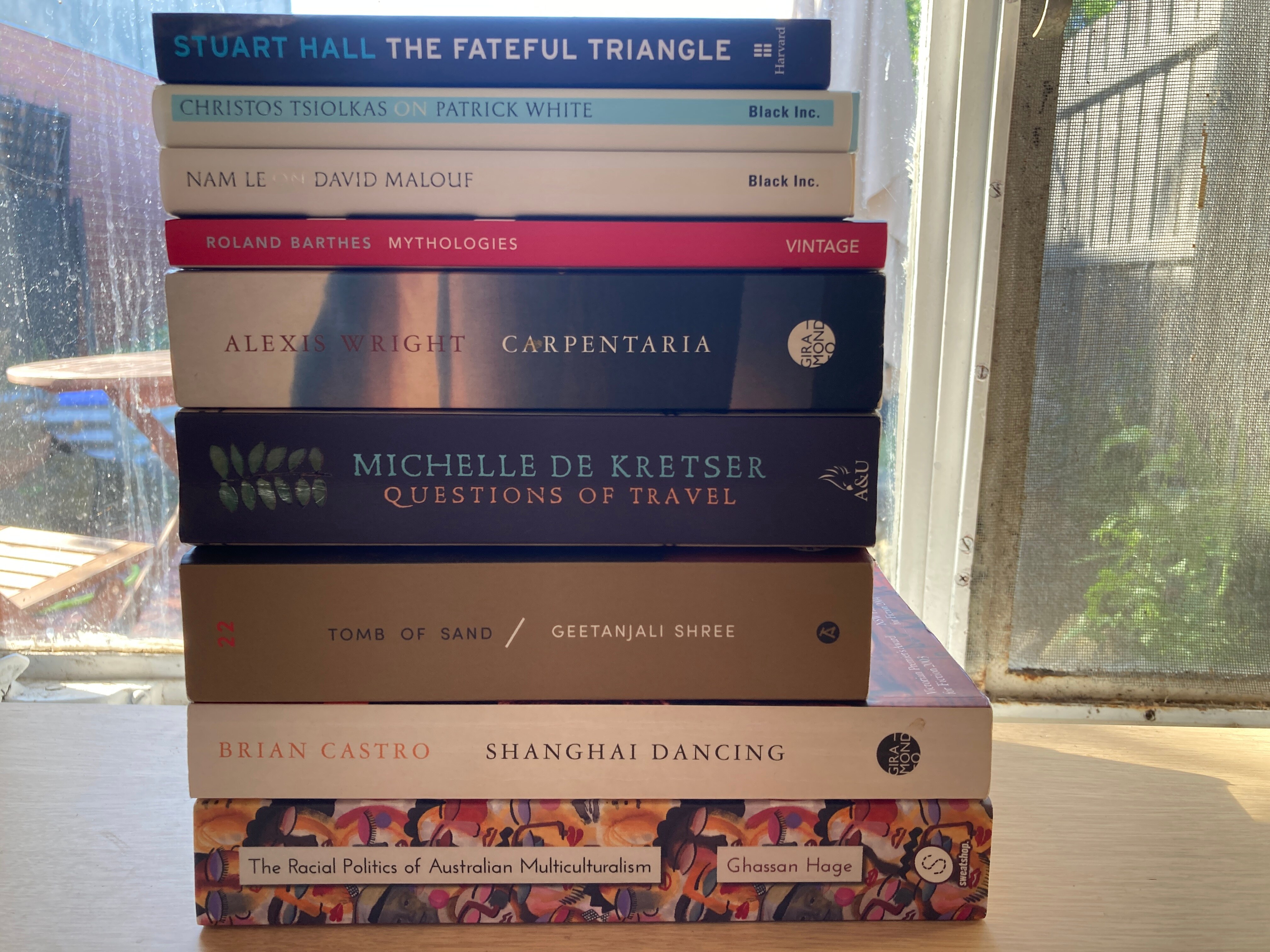 A pile of books that author André Dao is reading, including titles from Nam Le, Alexis Wright and Roland Bathes.