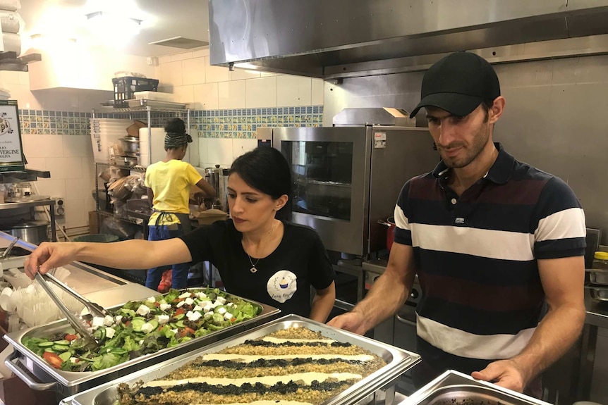 Two people working in a kitchen