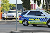 Police cars leave Melbourne Youth Justice Centre at Parkville