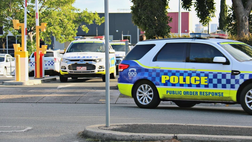 Police cars leave Melbourne Youth Justice Centre at Parkville