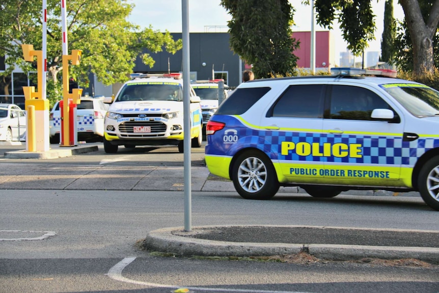 Police cars leave Melbourne Youth Justice Centre at Parkville