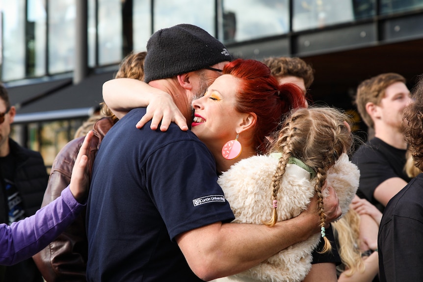 People hug in Yagan Square