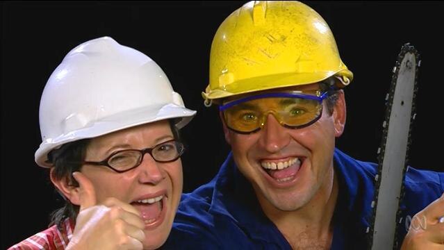 Woman and man smile while wearing hard hats