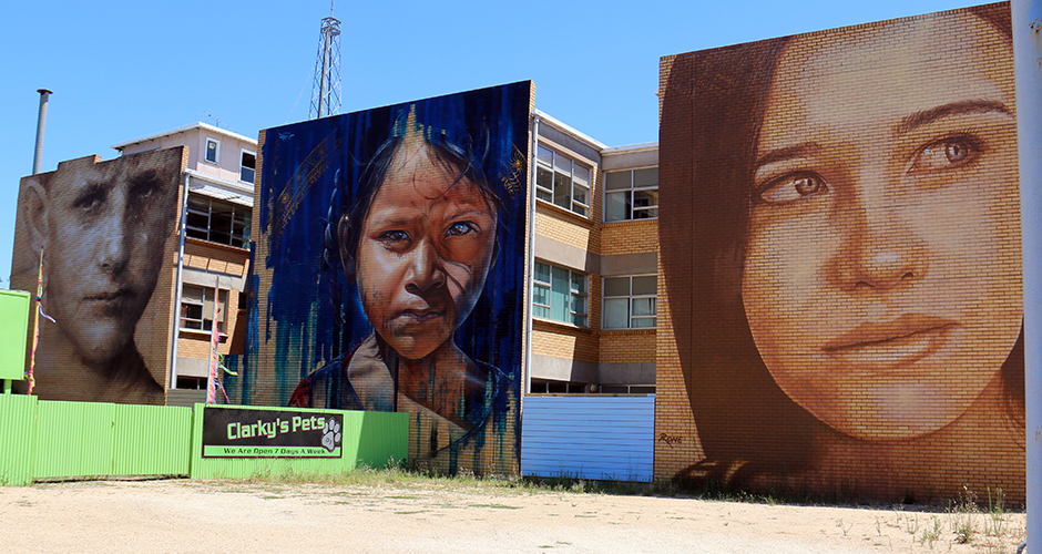 Works by Guido Van Helton, Adnate and Rone (left to right)  on the old SEC buildings in Benalla.