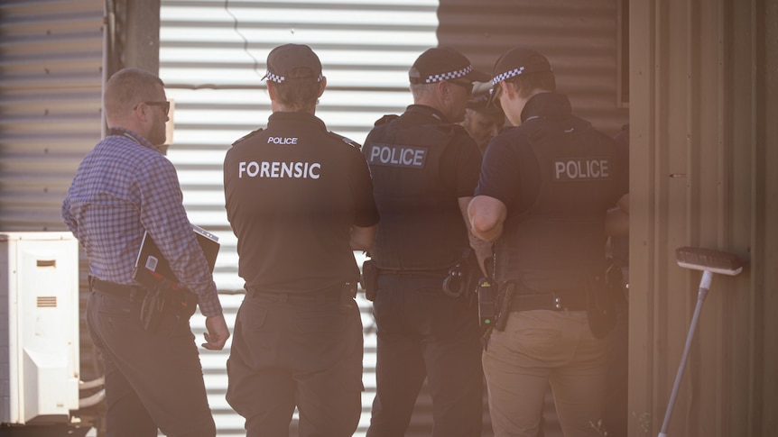 A group of police uniformed police officers with one plain-clothes officer. 