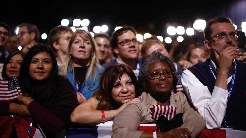 US president Barack Obama's supporters listen to his acceptance speech after winning the US presidential election.