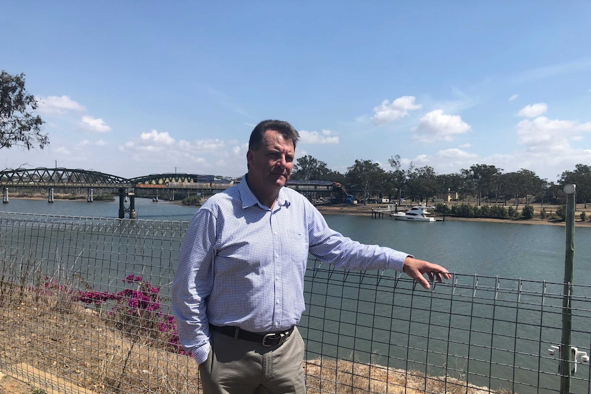 Queensland MP Stephen Bennett stands beside the Burnett River.