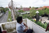 Kerobokan prison guard in watch tower with razor wire