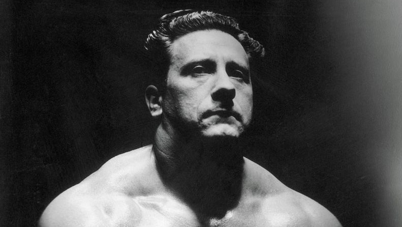 Joe Weider flexes his muscle