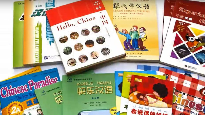 Books laid out with titles that include 'Hello, China', and 'Learn Chinese with me'.