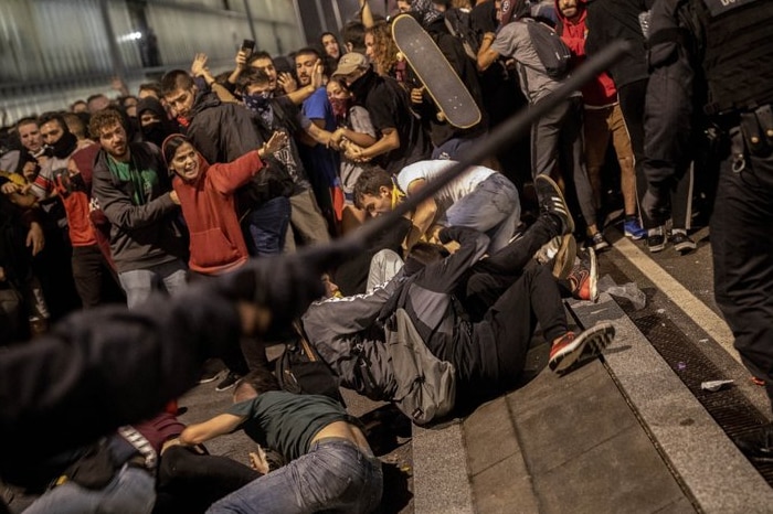 Police clash with protesters during a demonstration at El Prat airport