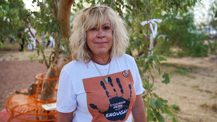 A woman wearing a t-shirt that says Coober Pedy says enough