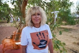 A woman wearing a t-shirt that says Coober Pedy says enough