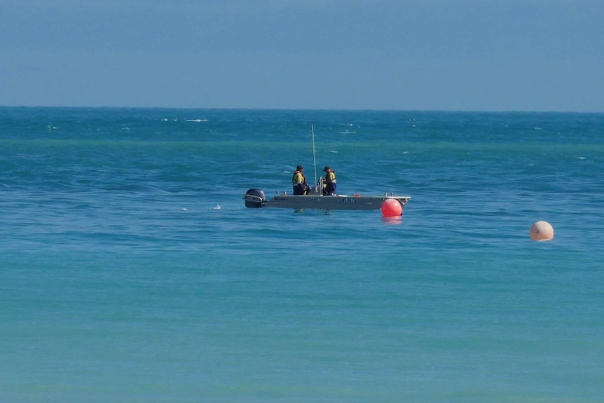 Men in a boat in the sea.