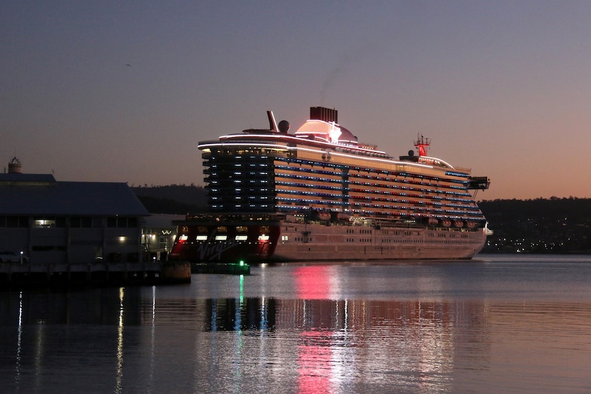 Un enorme crucero atracó en un muelle a primera hora de la mañana.