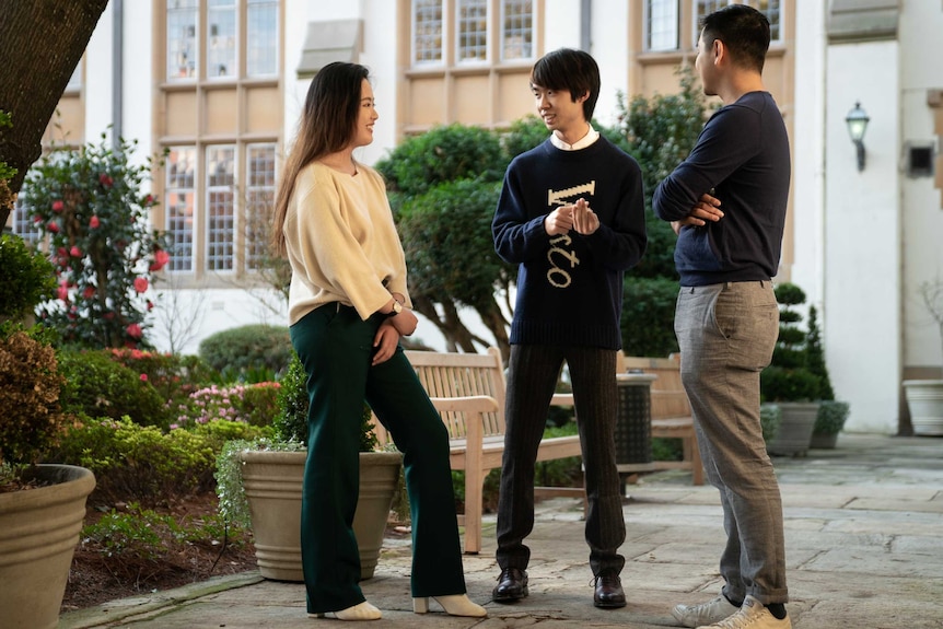 Clément Sun and his friend Abbey Shi talk in a courtyard in the University of Sydney.