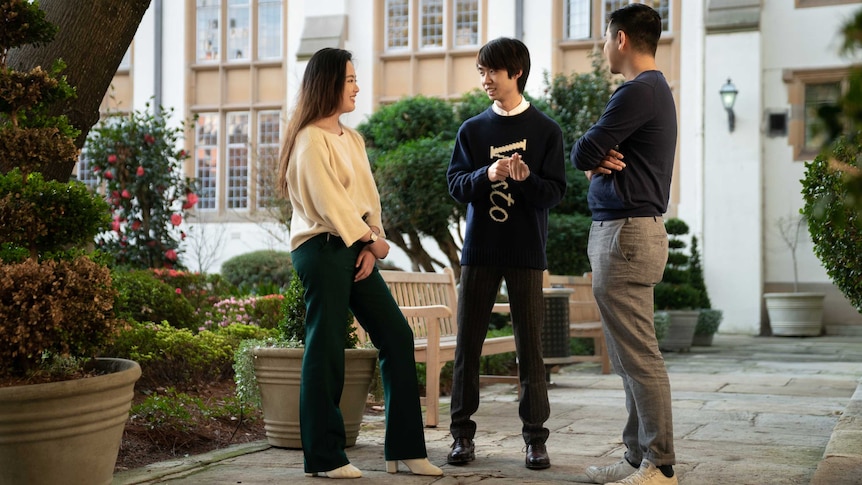 Clément Sun and his friend Abbey Shi talk in a courtyard in the University of Sydney.