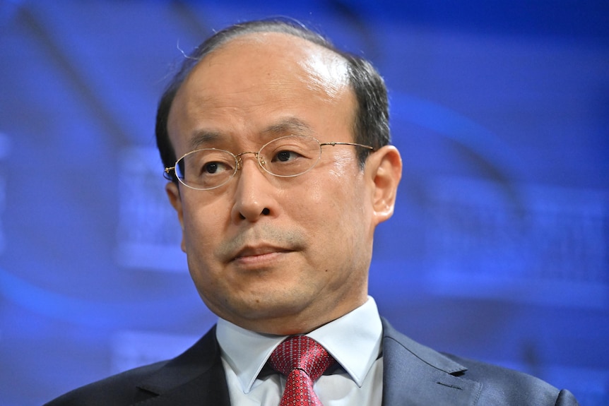 A close-up on balding Chinese man Xiao Qian.