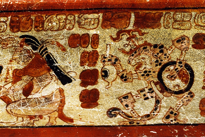 Jaguar character with enema syringe on Mayan pottery