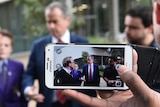 Bill Shorten is seen on a smartphone speaking with students at Melbourne University.