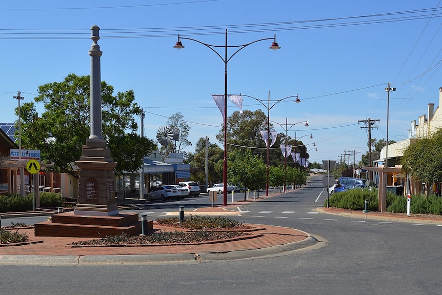 The main street of a country town beneath a clear sky.