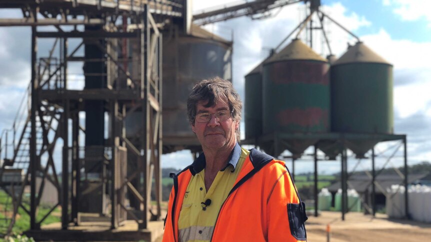 Macco Feeds Australia manager Phil Beresford standing in front of silos