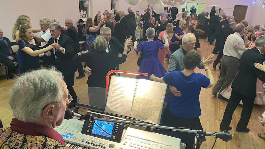Photo of lots of people dancing in a hall.