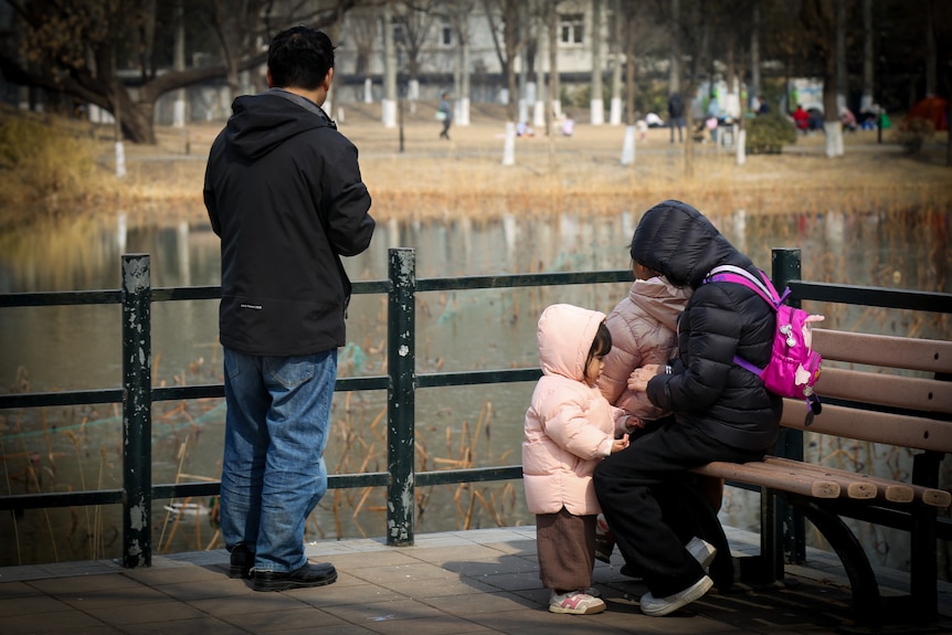 A mother and child by a lake 