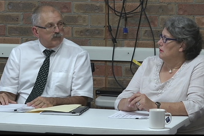 Greater Hume Shire General Manager Steven Pinnuck and Mayor Heather Wilton sitting at a table talk to each other.