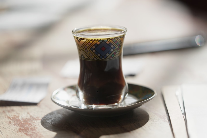 A decorative glass with coffee