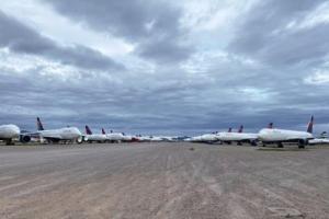 Rows of planes lined up in the desert.