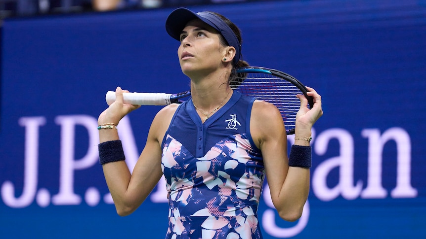Ajla Tomlijanovic looks up and holds her racquet behind her head