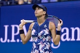 Ajla Tomlijanovic looks up and holds her racquet behind her head